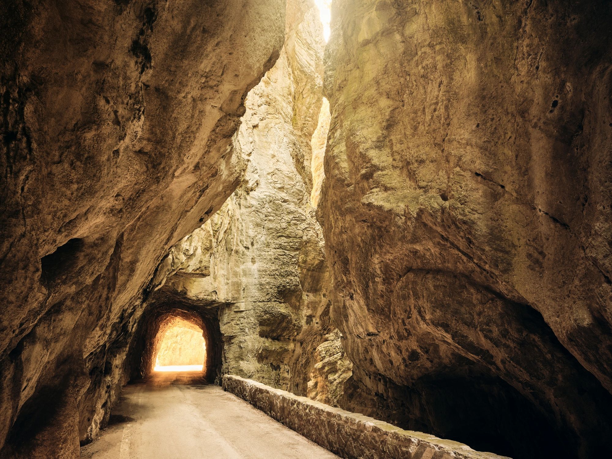 Road tunnel through mountainous terrain representing terrain-ready transportation delivery
